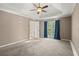 Another view of the main bedroom, with tray ceiling, ceiling fan, and entrance to another room at 4635 Rutledge Dr, Snellville, GA 30039