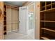Spacious walk-in closet featuring built-in shelving units and access to bathroom at 4635 Rutledge Dr, Snellville, GA 30039