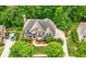 Aerial view of the home with a large driveway, lush landscaping, mature trees, and backyard deck at 4877 Registry Nw Ln, Kennesaw, GA 30152