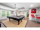 Basement area featuring a billiard table, bar stools, and a 'Bulldogs' sign; great for entertainment at 4877 Registry Nw Ln, Kennesaw, GA 30152