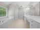 Bathroom featuring a tub, double vanity, large mirror, and tile floors at 4877 Registry Nw Ln, Kennesaw, GA 30152