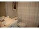 Well-lit bathroom featuring a toilet with a decorative shower curtain and framed art at 4877 Registry Nw Ln, Kennesaw, GA 30152