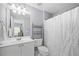 Bathroom featuring a single sink vanity, a toilet, and a shower with a patterned curtain at 4877 Registry Nw Ln, Kennesaw, GA 30152