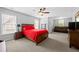 Bedroom with a queen-sized bed, a ceiling fan, and sitting area with a brown leather couch at 4877 Registry Nw Ln, Kennesaw, GA 30152