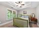 Cozy bedroom with tray ceiling, carpeted floors, and natural light, perfect for relaxation and rest at 4877 Registry Nw Ln, Kennesaw, GA 30152
