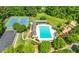 Aerial view of a community pool, tennis courts, a playground, and lush green landscaping at 4877 Registry Nw Ln, Kennesaw, GA 30152