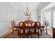 Formal dining room featuring hardwood floors, crown molding, chandelier, and bay window at 4877 Registry Nw Ln, Kennesaw, GA 30152