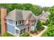 Attractive exterior view of a multi-story home with a brick chimney, a mix of siding, and manicured landscaping at 4877 Registry Nw Ln, Kennesaw, GA 30152