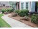 Well-maintained front yard with mature landscaping, a brick walkway, and a mix of colorful plantings at 4877 Registry Nw Ln, Kennesaw, GA 30152