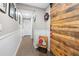 Hallway featuring a wood accent wall, white walls, and a view to other rooms in the house at 4877 Registry Nw Ln, Kennesaw, GA 30152