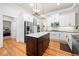Modern kitchen with white cabinets, stainless steel appliances, and a dark wood island, adjacent to bedroom at 4877 Registry Nw Ln, Kennesaw, GA 30152