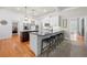 Well-lit kitchen with white cabinets, stainless steel appliances, and a center island with barstool seating at 4877 Registry Nw Ln, Kennesaw, GA 30152