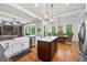 Bright open kitchen with white cabinets, stainless steel appliances, island and hardwood flooring at 4877 Registry Nw Ln, Kennesaw, GA 30152