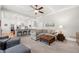 Bright, open-concept living room with a modern ceiling fan and large sectional sofa, next to island at 4877 Registry Nw Ln, Kennesaw, GA 30152