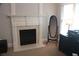 Living room featuring a fireplace with an ornate mantel, large mirror, and built-in cabinetry at 4877 Registry Nw Ln, Kennesaw, GA 30152