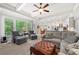 Sun-filled living room with large windows, comfortable seating, and view of the kitchen at 4877 Registry Nw Ln, Kennesaw, GA 30152
