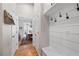 Bright mudroom with shiplap walls, built-in bench, and views into the dining room at 4877 Registry Nw Ln, Kennesaw, GA 30152