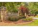 Neighborhood entrance with a stone sign for Burnt Hickory Registry and lush landscaping at 4877 Registry Nw Ln, Kennesaw, GA 30152
