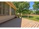 Wonderful backyard featuring a wood deck with railing and bench, offering a peaceful view of the greenery at 1551 Pharrs Rd., Snellville, GA 30078
