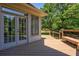 Beautiful backyard with a wood deck, French doors, bench and view of the manicured lawn at 1551 Pharrs Rd., Snellville, GA 30078