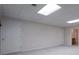 A finished basement space with neutral carpet and basic lighting at 1551 Pharrs Rd., Snellville, GA 30078