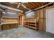 Unfinished basement space with pegboard wall and workbenches at 1551 Pharrs Rd., Snellville, GA 30078