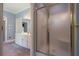 Bright bathroom with a glass shower, double sink vanity, and view to bedroom at 1551 Pharrs Rd., Snellville, GA 30078