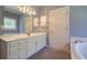 Well-lit bathroom featuring a tub, stained glass window, and an expansive vanity at 1551 Pharrs Rd., Snellville, GA 30078