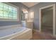 Relaxing bathroom with a jacuzzi-style bathtub and stained glass window at 1551 Pharrs Rd., Snellville, GA 30078