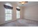 Bedroom featuring carpet flooring and two large windows at 1551 Pharrs Rd., Snellville, GA 30078