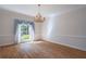 Elegant dining room featuring a chandelier, hardwood floors, and natural light at 1551 Pharrs Rd., Snellville, GA 30078