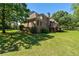 Brick home exterior with large yard, featuring a wood deck perfect for outdoor activities at 1551 Pharrs Rd., Snellville, GA 30078