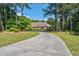 Beautiful brick home featuring manicured landscaping and long driveway at 1551 Pharrs Rd., Snellville, GA 30078