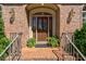 Close up view of a beautiful front door with red brick and a small stoop at 1551 Pharrs Rd., Snellville, GA 30078