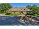 Charming brick home with a circular driveway, well-maintained landscaping, and a welcoming entrance, perfect for families at 1551 Pharrs Rd., Snellville, GA 30078