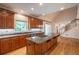 Charming kitchen with large island, custom cabinets, and hardwood floors at 1551 Pharrs Rd., Snellville, GA 30078
