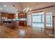 Open kitchen with hardwood floors and door leading to bright sunroom at 1551 Pharrs Rd., Snellville, GA 30078