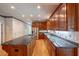 Modern kitchen with stainless steel appliances, large granite counters, and hardwood floors at 1551 Pharrs Rd., Snellville, GA 30078