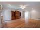 Spacious living room with hardwood floors, a brick fireplace, and custom wooden built-ins at 1551 Pharrs Rd., Snellville, GA 30078