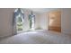 Sunlit living room featuring large windows with elegant curtains and neutral carpet at 1551 Pharrs Rd., Snellville, GA 30078