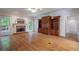 Bright living room featuring hardwood floors, a brick fireplace, and built-in wooden bookshelves at 1551 Pharrs Rd., Snellville, GA 30078