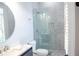 Bathroom featuring a marble shower with a glass door, and marble countertops with modern fixtures at 2015 Shaudi Ln, Atlanta, GA 30345