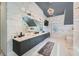 Luxurious bathroom featuring marble walls, dual sinks, modern lighting, and a contemporary design at 2015 Shaudi Ln, Atlanta, GA 30345