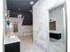 Modern bathroom with dual vanities, high ceilings, custom lighting, marble accents, and a walk-in shower at 2015 Shaudi Ln, Atlanta, GA 30345
