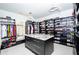 Custom walk-in closet with shelving, drawers, storage, and a center island at 2015 Shaudi Ln, Atlanta, GA 30345