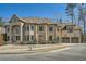 Stunning two-story brick home with stone accents, attached garage, manicured lawn, and beautiful architectural details at 2015 Shaudi Ln, Atlanta, GA 30345