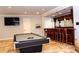 Entertainment room featuring a pool table, bar with seating, and mounted television at 2015 Shaudi Ln, Atlanta, GA 30345