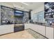 Modern kitchen boasts stainless steel appliances, eye-catching marble backsplash, and stylish white cabinets at 2015 Shaudi Ln, Atlanta, GA 30345