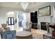 Bright living room with fireplace, modern lighting, an open staircase, and stylish decor at 2015 Shaudi Ln, Atlanta, GA 30345