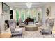 Cozy living room with fireplace, large windows, high ceilings, and stylish patterned chairs and sofas at 2015 Shaudi Ln, Atlanta, GA 30345